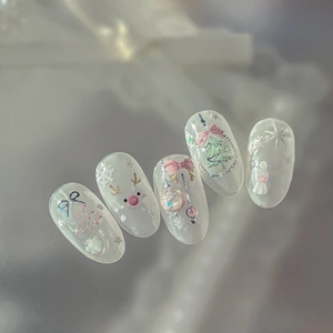 Pink Christmas press-on nails featuring 3D reindeer, snowflake, and tree designs