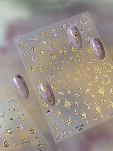 Detailed view of celestial nail stickers featuring gold foil sun, moon, and stars
