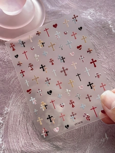Detailed view of YT7478 nail stickers featuring cross and heart patterns on checkered base