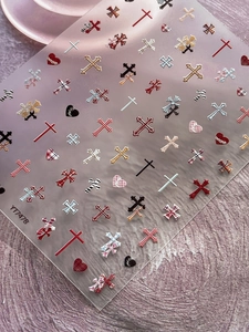Detail of embossed cross and heart patterns on professional nail art sticker sheets