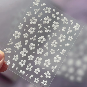 5D embossed white floral nail art stickers with minimalist relief texture on clear film