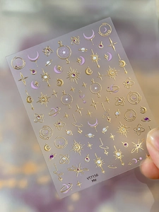 Detail of gold moon and star embossed nail stickers with Y2K celestial patterns