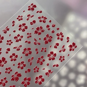 3D floral embossed nail art stickers with red flower patterns on matte background