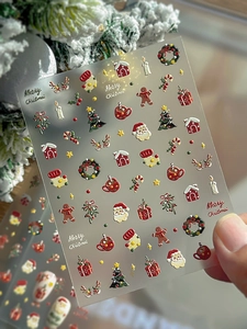 Detailed 5D embossed nail stickers featuring 3D Santa and gingerbread man designs