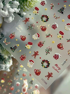 Detail of 3D embossed Santa Claus and Christmas tree nail art stickers in cartoon style