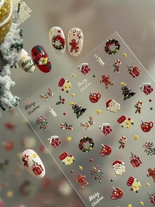 Macro detail of 3D embossed Christmas nail stickers featuring Santa Claus and reindeer