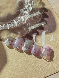 Detail of luxury lavender marble press-on nails with sparkling glitter and rhinestones