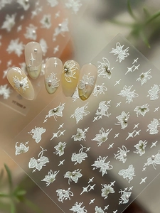 Detailed 5D embossed butterfly nail stickers with pearls on a gradient manicure
