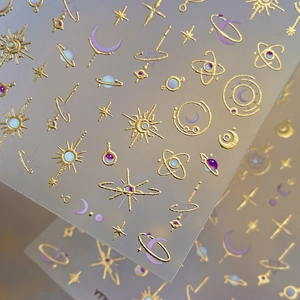 Golden celestial nail stickers with sun moon and star patterns for Y2K style beauty