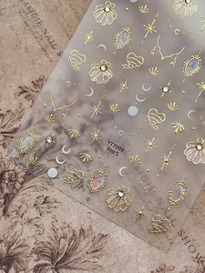 Macro detail of YT7099 gold nail stickers with retro shell and star patterns