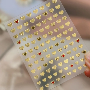 Embossed gold heart nail art stickers with 3D metallic textures for creative DIY manicure