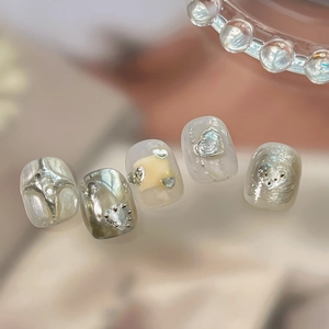 Modern Y2K cat-eye press-on nails with 3D silver heart and star metal embellishments