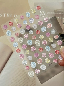 Detail showing 3D embossed rose and heart nail stickers in macaron pink and blue