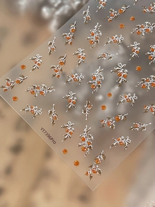 Macro shot of 3D embossed orange berry and silver leaf nail stickers on YT7396Pro sheet