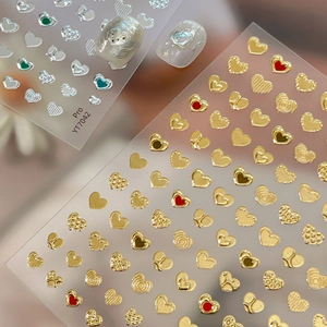 3D gold heart nail stickers with metallic textures and embossed details on nails