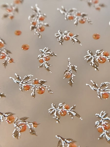 3D embossed nail stickers featuring winter persimmon and white snow patterns in warm orange