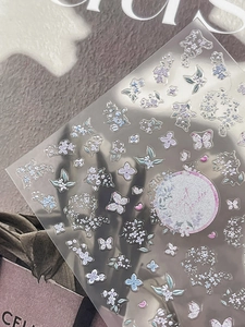 Detail of Secret Garden nail stickers with glitter purple and blue butterfly patterns