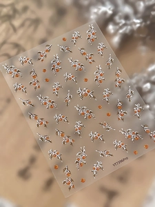 Macro shot of 3D embossed botanical nail stickers with silver branches and orange berries