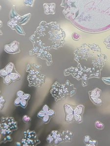 Detailed macro view of holographic butterfly floral nail stickers with iridescent finish