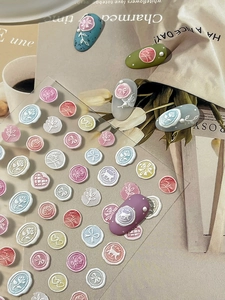 Detailed 3D embossed nail stickers featuring floral wax seals and heart patterns