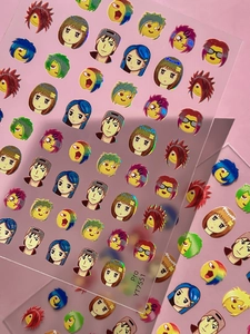 Macro detail of laser holographic nail stickers featuring colorful anime character designs