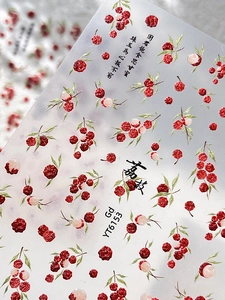 Macro detail of summer lychee nail stickers with embossed textures and Chinese motifs