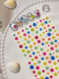 Macro shot of 3D colorful monster eye nail stickers and silver glitter press-on nails
