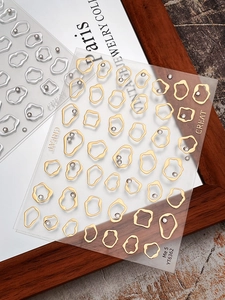 Detail of gold and silver irregular frame nail stickers with pearls and rhinestones