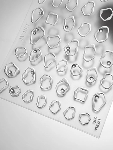Detail view of 3D metallic silver irregular nail art stickers with sparkling rhinestones
