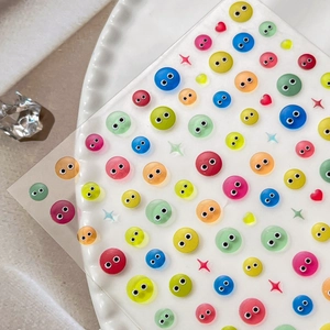 Colorful relief cartoon eye nail stickers with 3D jelly effect on white ceramic plate