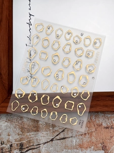 Macro detail of YT6362 gold geometric nail stickers with rhinestones on clear film