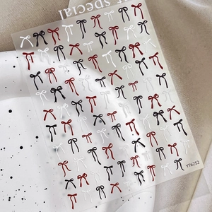Autocollants ongles 3D en relief avec nœuds rouges noirs et blancs au design élégant