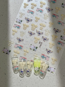 Macro shot of 3D embossed summer beach nail art stickers with swimsuit designs