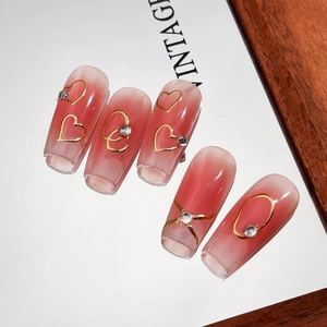 Pink gradient long coffin press-on nails with golden hearts and silver rhinestones