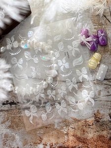 Macro detail of YT6404 butterfly nail art stickers with aurora shell sheen and pearl chain