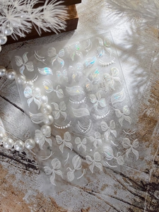Detail of 3D aurora bowknot nail art stickers with pearls and butterfly patterns