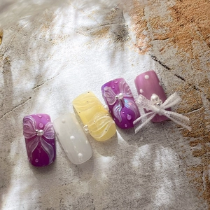 Exquisite handmade bow press-on nails with pearl accents and floral patterns