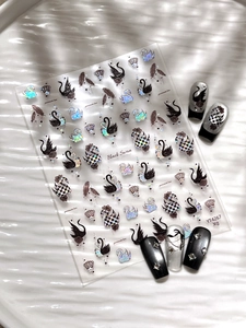 Macro detail of black swan nail art stickers with laser silver finish and grid patterns