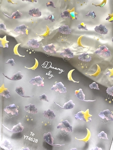 Detail of laser purple cloud nail stickers with yellow crescent moon and star patterns