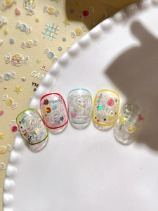 Detail of candy-themed 3D embossed nail art stickers with vibrant macaron sequins