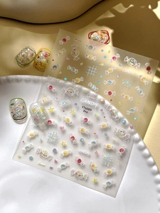 Detail of sweet candy nail stickers with glitter stars and hearts on a white plate