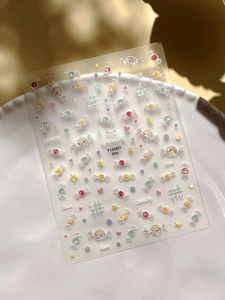 Detail of 3D candy nail art stickers with rainbow holographic finish on ceramic plate