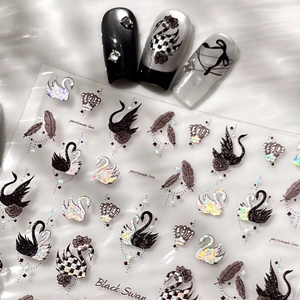 Sparkling black swan nail stickers with glitter crowns and feathers on white silk