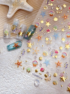 Detail showing 3D embossed sea shell and golden starfish nail art stickers with pearls