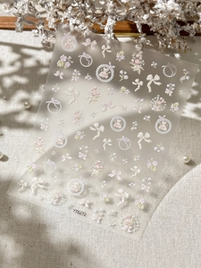 Detailed relief nail stickers featuring bows, bears, and floral patterns in soft pastel tones