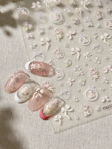 Detailed 3D embossed nail stickers featuring tulip bouquets and pink bow designs
