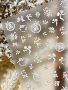 Macro detail of 3D embossed nail stickers with tulip, bear and bow designs