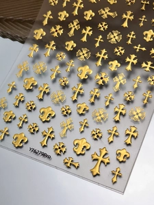 Vue détaillée des stickers 3D dorés métallisés pour ongles avec croix et fleur de lys