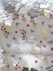 Macro detail of Chinese style nail stickers featuring golden butterfly and plum blossoms