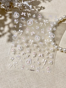 Detailed close-up of 3D embossed nail art stickers with pink bows and cute bears